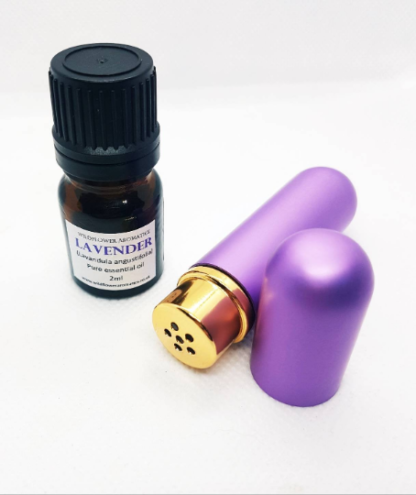 A purple aromatherapy inhaler stick, with the lid off